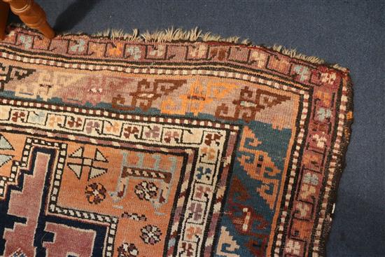 A Derbend apricot ground rug, c.1910, 9ft 6in by 3ft 6in.